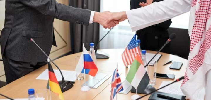 Two intercultural delegates shaking hands after a successful meeting