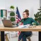 a girl studying while at the desk with a laptop on the desk in the office