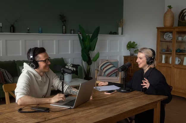A man and a woman recording a podcast
