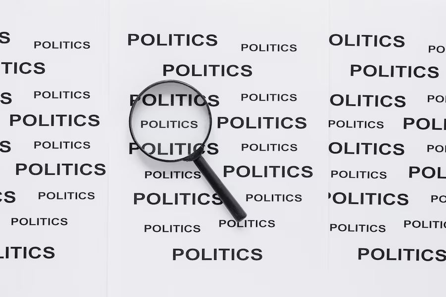Paper displaying the word "politics" repeatedly, with a magnifying glass