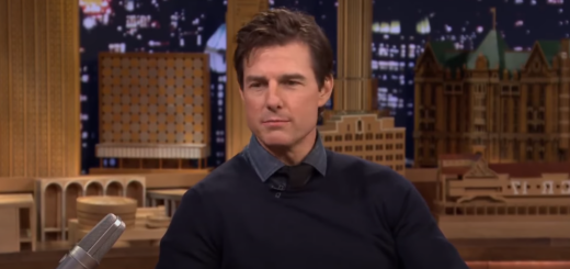 Tom Cruise during an interview with a backdrop of a building