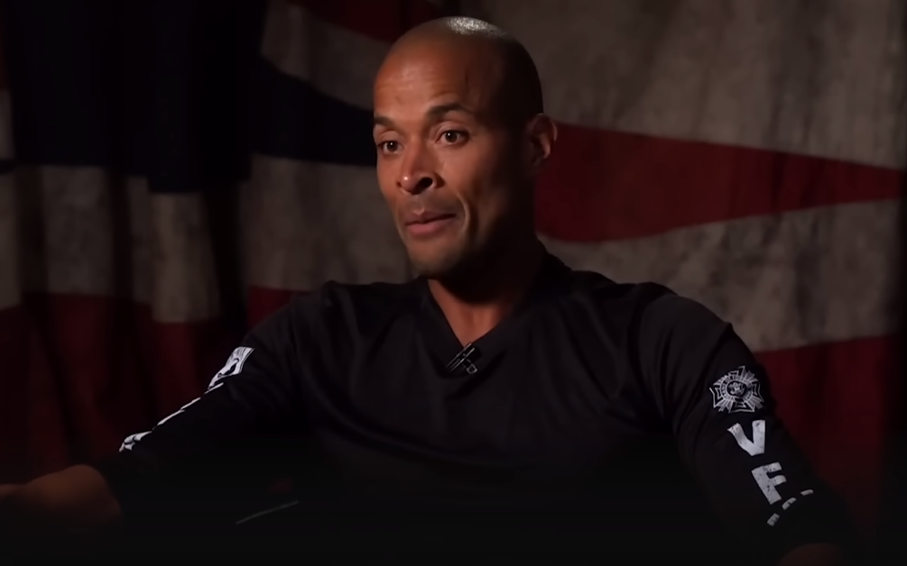 David Goggins with a flag-themed backdrop