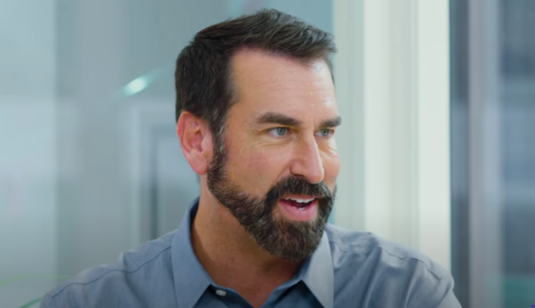 Rob Riggle with a smiling expression