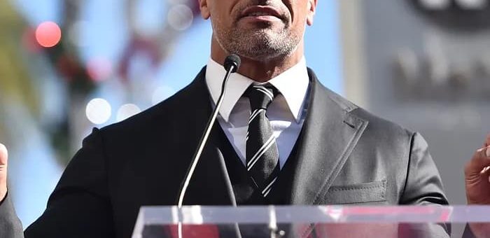 Dwayne Johnson speaking on the podium