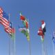 avenue of flags of different countries on flagpoles